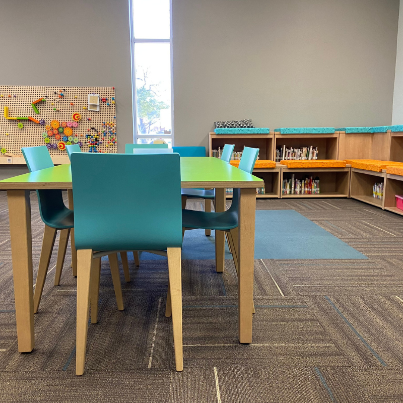 Commercial, patterned carpet in a local library's kids' area with colorful furniture.