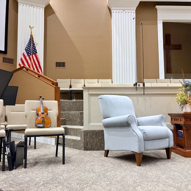 Damask patterned commercial carpet in a traditional church sanctuary stage with a violin.