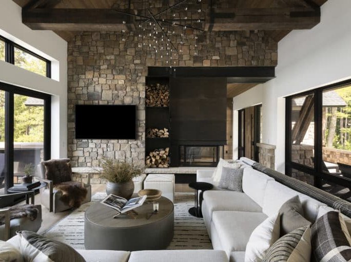 rustic living room with large stone fireplace