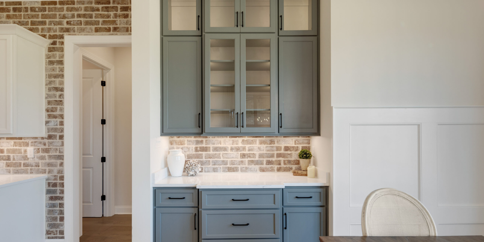 Modern kitchen with exposed brick, board & batten and gray-blue cabinets, hardwood floors, renovation